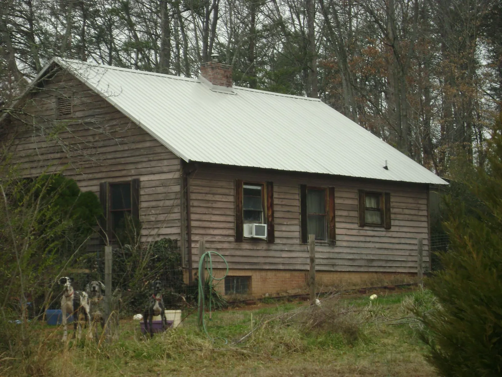 White metal roof on an old wood sided farmhouse, from a Metal Roof Installation job in Mentor